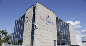 Modern building with BioVectra logo, featuring large glass windows and a clear blue sky. No recognizable landmarks or persons are visible.